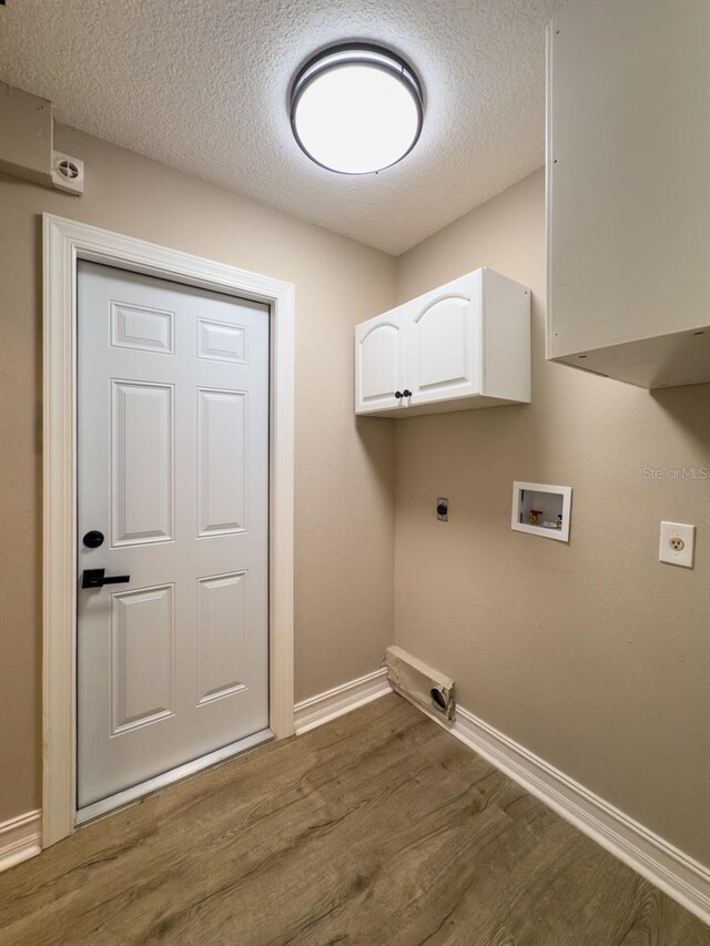 4044 Red Fox Ct, Wesley Chapel, FL 33543 - washroom featuring electric dryer hookup, cabinet space, wood finished floors, washer hookup, and baseboards