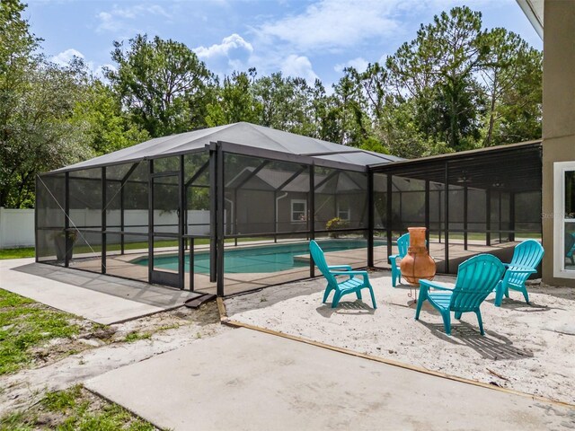 4044 Red Fox Ct, Wesley Chapel, FL 33543 - outdoor pool featuring a patio area and glass enclosure