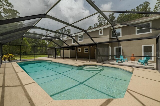 4044 Red Fox Ct, Wesley Chapel, FL 33543 - swimming pool featuring a patio area and glass enclosure