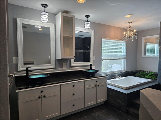 4044 Red Fox Ct, Wesley Chapel, FL 33543 - bathroom with a garden tub, vanity, and a chandelier