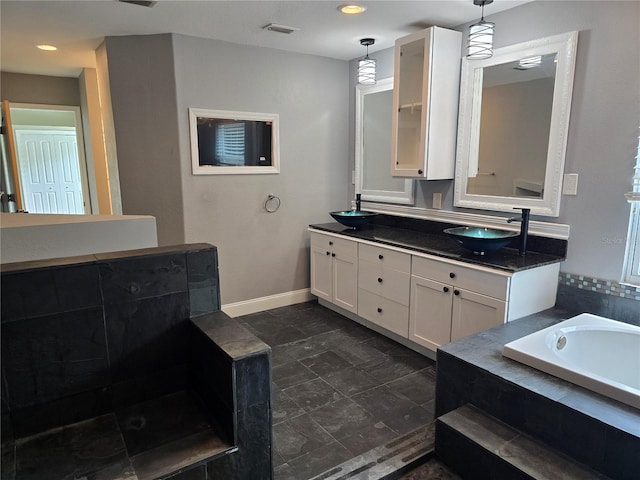 4044 Red Fox Ct, Wesley Chapel, FL 33543 - bathroom featuring a garden tub, double vanity, baseboards, and recessed lighting