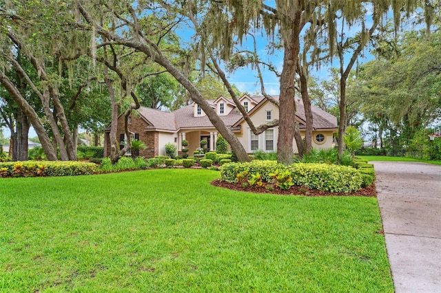 17802 Mission Oak Dr, Lithia, FL 33547 - view of front of house with a front lawn, stucco siding, and concrete driveway