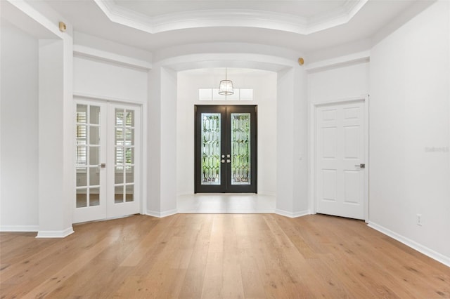 17802 Mission Oak Dr, Lithia, FL 33547 - foyer entrance with french doors, hardwood / wood-style floors, healthy amount of natural light, arched walkways, and crown molding