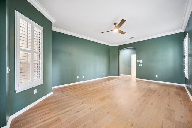 17802 Mission Oak Dr, Lithia, FL 33547 - empty room featuring arched walkways, ceiling fan, ornamental molding, wood finished floors, and baseboards