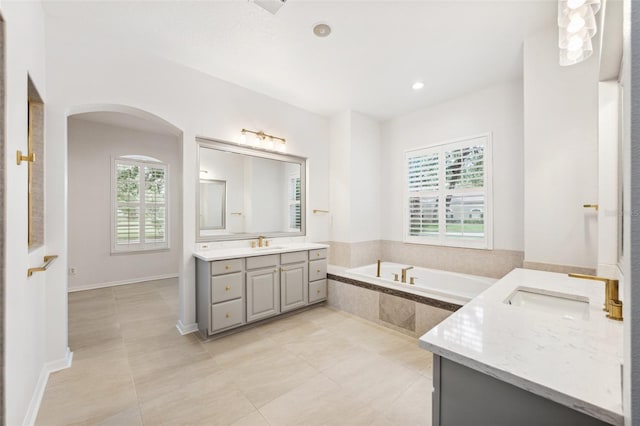 17802 Mission Oak Dr, Lithia, FL 33547 - bathroom with two vanities, a garden tub, tile patterned flooring, and recessed lighting