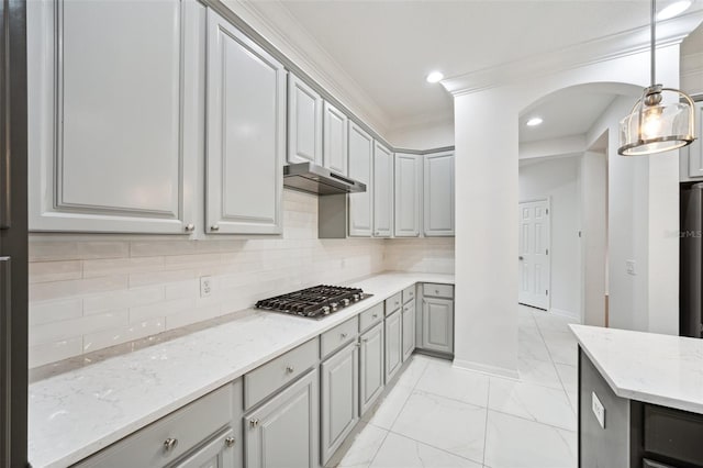 17802 Mission Oak Dr, Lithia, FL 33547 - kitchen with gray cabinetry, stainless steel gas cooktop, under cabinet range hood, light marble finish flooring, and light stone countertops