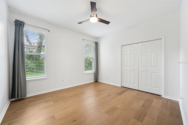 17802 Mission Oak Dr, Lithia, FL 33547 - unfurnished bedroom featuring multiple windows, light wood-type flooring, and baseboards
