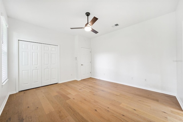 17802 Mission Oak Dr, Lithia, FL 33547 - unfurnished bedroom with light wood-style flooring, baseboards, a closet, and ceiling fan
