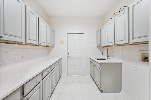 17802 Mission Oak Dr, Lithia, FL 33547 - laundry area with light marble finish flooring, cabinet space, washer hookup, and baseboards