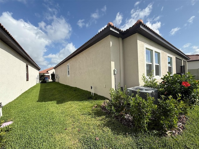 17304 Scuba Crest St, Wimauma, FL 33598 - view of side of property featuring stucco siding and a yard