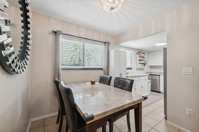 11809 Raintree Lake Ln Unit A, Tampa, FL 33617 - dining space with baseboards, light tile patterned floors, and a textured ceiling