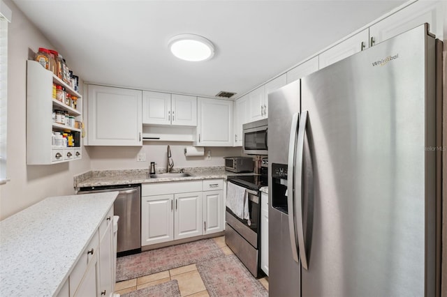 11809 Raintree Lake Ln Unit A, Tampa, FL 33617 - kitchen with appliances with stainless steel finishes, a sink, open shelves, white cabinetry, and light tile patterned flooring