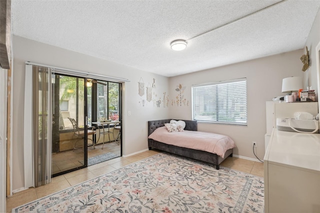 11809 Raintree Lake Ln Unit A, Tampa, FL 33617 - bedroom with multiple windows, access to outside, light tile patterned floors, and a textured ceiling