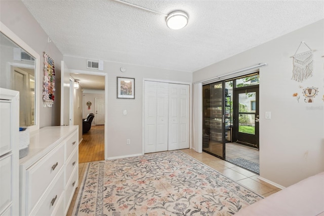 11809 Raintree Lake Ln Unit A, Tampa, FL 33617 - entrance foyer with a textured ceiling, light tile patterned floors, and baseboards