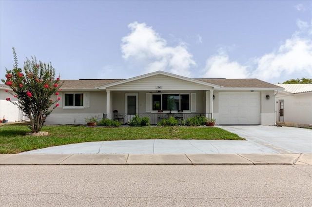 5840 Liddell Dr, New Port Richey, FL 34652 - single story home featuring covered porch, driveway, a garage, a front lawn, and stucco siding