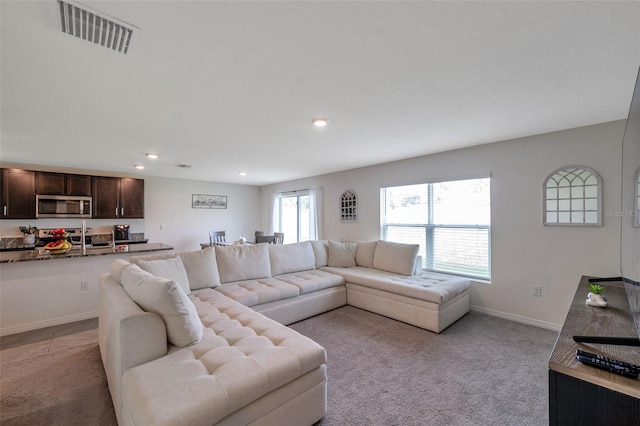 7641 Sail Clover Ln, Zephyrhills, FL 33540 - living room featuring light carpet, recessed lighting, and baseboards