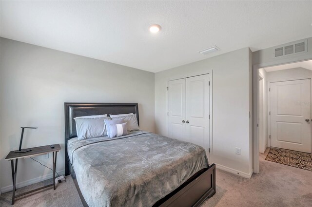 7641 Sail Clover Ln, Zephyrhills, FL 33540 - bedroom featuring light carpet, baseboards, and a closet