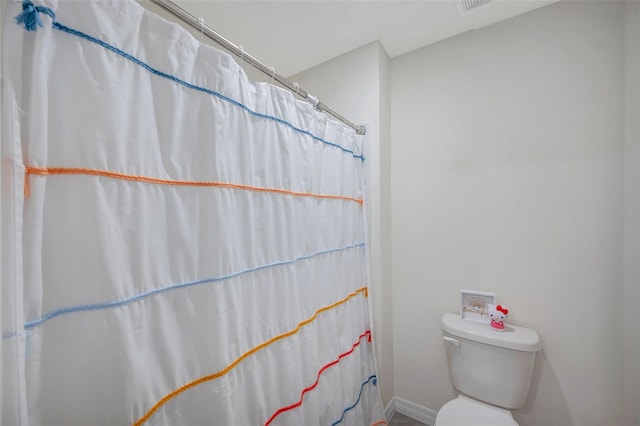7641 Sail Clover Ln, Zephyrhills, FL 33540 - full bathroom with toilet, baseboards, and a shower with shower curtain