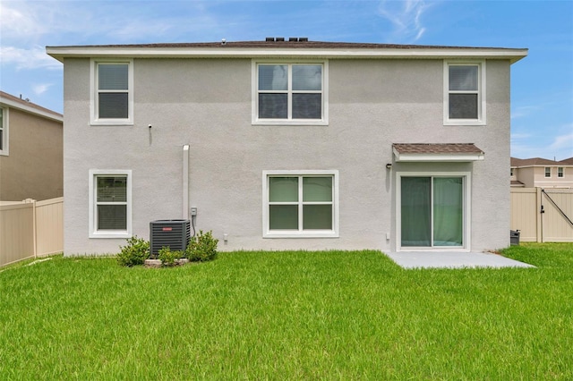 7641 Sail Clover Ln, Zephyrhills, FL 33540 - rear view of house with central air condition unit, stucco siding, and a gate