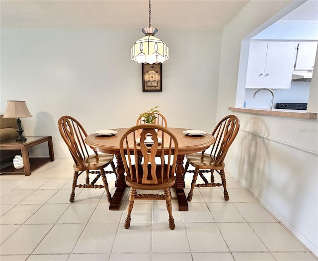 13926 Mission Oaks Blvd, Seminole, FL 33776 - dining space with light tile patterned flooring and baseboards