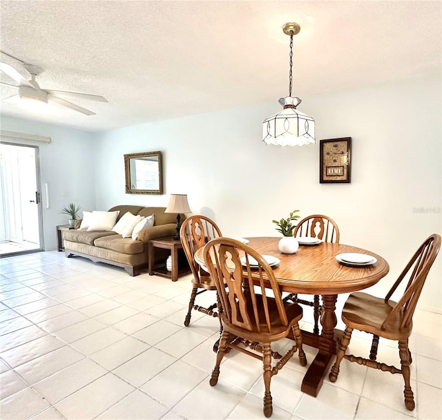 13926 Mission Oaks Blvd, Seminole, FL 33776 - dining room with ceiling fan, light tile patterned floors, and a textured ceiling