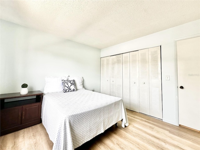 13926 Mission Oaks Blvd, Seminole, FL 33776 - bedroom featuring light wood-style flooring, a textured ceiling, and a closet