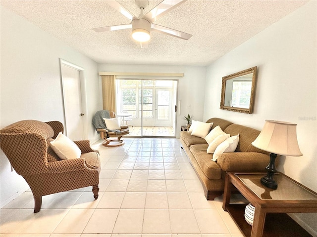 13926 Mission Oaks Blvd, Seminole, FL 33776 - living area featuring a textured ceiling, a ceiling fan, and light tile patterned flooring