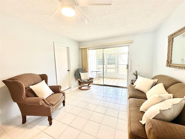 13926 Mission Oaks Blvd, Seminole, FL 33776 - living room featuring a textured ceiling, light tile patterned floors, and a ceiling fan