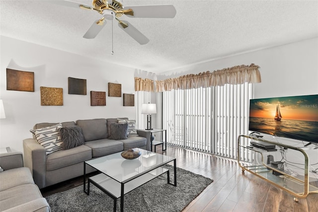 2699 Pine Ridge Way E Unit H2, Palm Harbor, FL 34684 - living room featuring a textured ceiling, wood finished floors, and ceiling fan