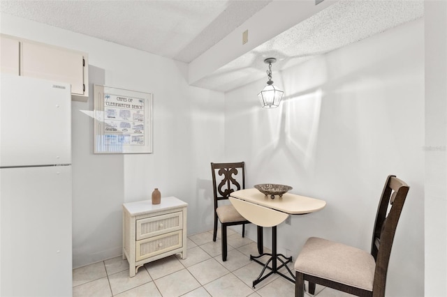 2699 Pine Ridge Way E Unit H2, Palm Harbor, FL 34684 - dining area featuring light tile patterned flooring and a textured ceiling