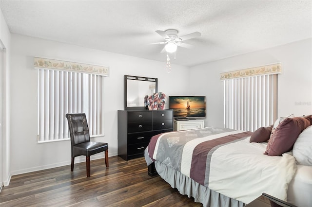 2699 Pine Ridge Way E Unit H2, Palm Harbor, FL 34684 - bedroom featuring dark wood-type flooring, a ceiling fan, and a textured ceiling
