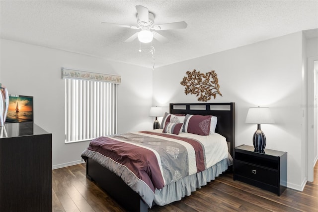 2699 Pine Ridge Way E Unit H2, Palm Harbor, FL 34684 - bedroom with a textured ceiling, dark wood-style flooring, and a ceiling fan