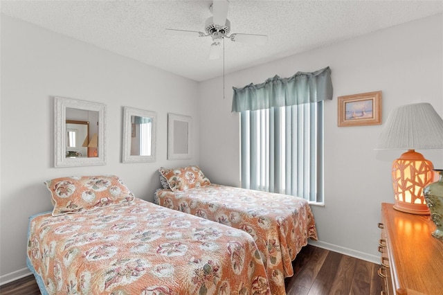 2699 Pine Ridge Way E Unit H2, Palm Harbor, FL 34684 - bedroom featuring dark wood-type flooring, a textured ceiling, and a ceiling fan