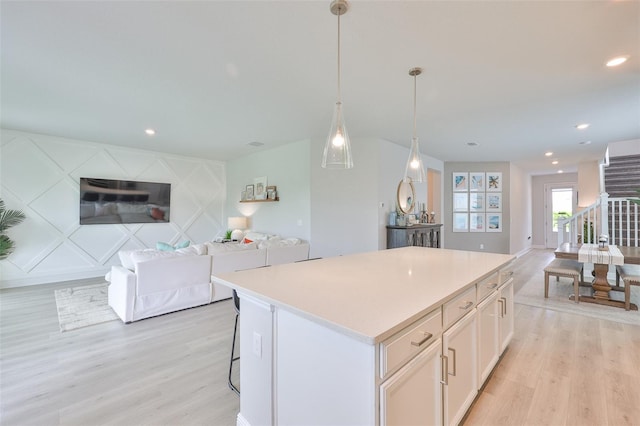 5511 Del Coronado Dr, Apollo Beach, FL 33572 - kitchen with open floor plan, light wood finished floors, a kitchen island, light countertops, and recessed lighting