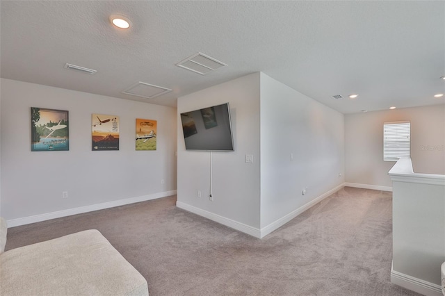 5511 Del Coronado Dr, Apollo Beach, FL 33572 - unfurnished living room featuring carpet floors, baseboards, a textured ceiling, recessed lighting, and attic access