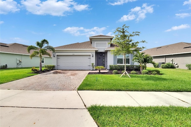 11785 Little River Way, Parrish, FL 34219 - view of front of property featuring decorative driveway, an attached garage, stucco siding, and a front yard