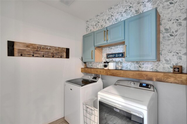 11785 Little River Way, Parrish, FL 34219 - laundry area with cabinet space, washing machine and clothes dryer, wallpapered walls, light wood finished floors, and baseboards