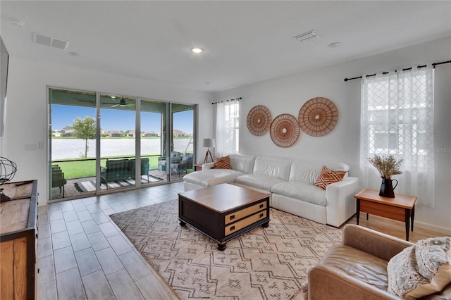 11785 Little River Way, Parrish, FL 34219 - living room with a water view, recessed lighting, ceiling fan, and wood finished floors
