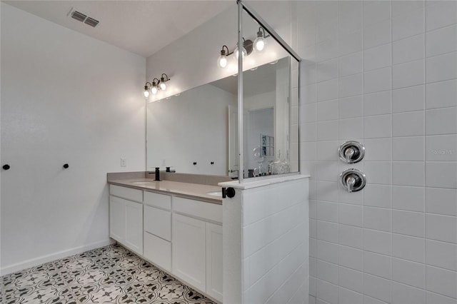 11785 Little River Way, Parrish, FL 34219 - full bath featuring double vanity, a walk in shower, baseboards, and tile patterned floors