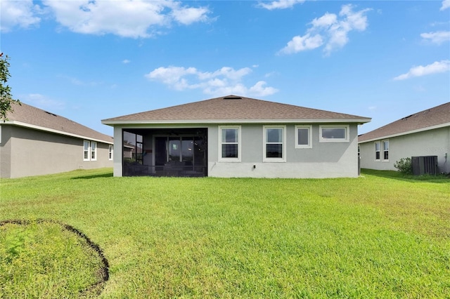 11785 Little River Way, Parrish, FL 34219 - back of house with a sunroom, stucco siding, a lawn, and central AC unit