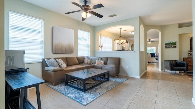 14320 Tree Swallow Way, Lakewood Ranch, FL 34202 - living area with a ceiling fan, arched walkways, light tile patterned floors, a chandelier, and baseboards