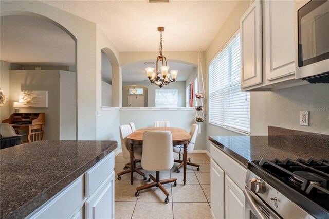 14320 Tree Swallow Way, Lakewood Ranch, FL 34202 - dining room with a chandelier, light tile patterned floors, healthy amount of natural light, and baseboards