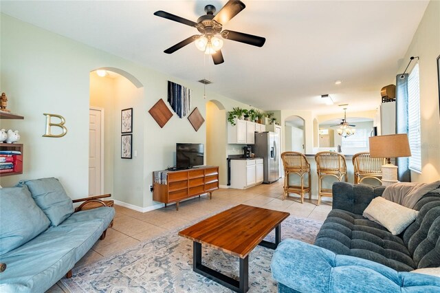 14320 Tree Swallow Way, Lakewood Ranch, FL 34202 - living area with arched walkways, a ceiling fan, light tile patterned floors, and baseboards