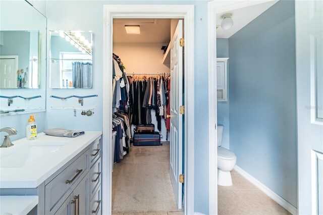 14320 Tree Swallow Way, Lakewood Ranch, FL 34202 - full bath featuring vanity, toilet, a spacious closet, baseboards, and tile patterned flooring