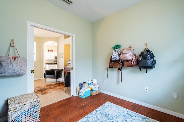14320 Tree Swallow Way, Lakewood Ranch, FL 34202 - game room with arched walkways, hardwood / wood-style floors, and baseboards