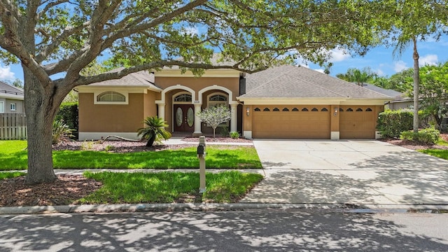 5519 Reflections Blvd, Lutz, FL 33558 - mediterranean / spanish home with a garage, stucco siding, concrete driveway, and roof with shingles