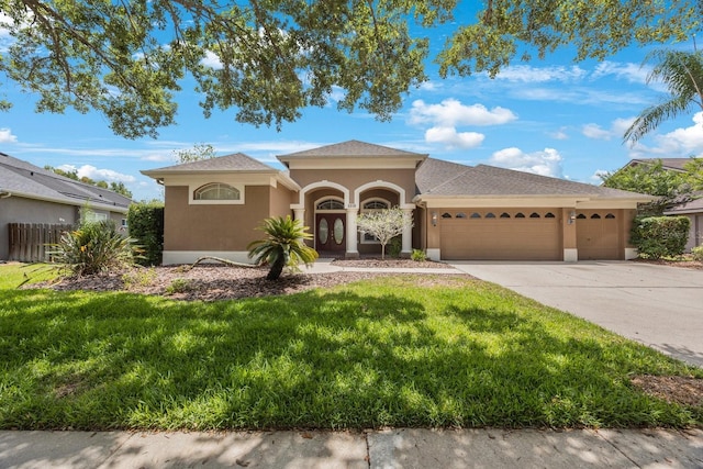 5519 Reflections Blvd, Lutz, FL 33558 - mediterranean / spanish-style house with an attached garage, stucco siding, a front yard, and driveway