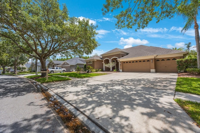 5519 Reflections Blvd, Lutz, FL 33558 - view of front of home with stucco siding, an attached garage, and driveway