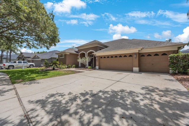 5519 Reflections Blvd, Lutz, FL 33558 - ranch-style house featuring a garage, concrete driveway, stucco siding, and a front yard