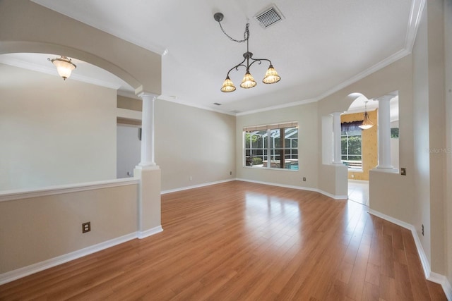 5519 Reflections Blvd, Lutz, FL 33558 - empty room featuring ornate columns, arched walkways, light wood-type flooring, ornamental molding, and baseboards